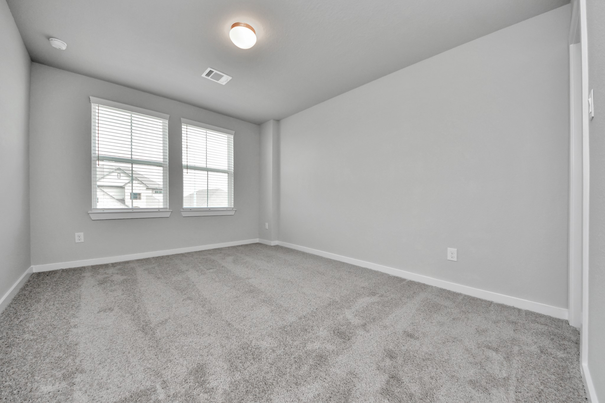 11114 Tulip Rdg Trail Houston, TX 77044 - Photo 26 of 30 Secondary bedroom features plush carpeting, large windows that let in plenty of natural light, bright paint, and spacious closets. Sample photo of completed home with similar floor plan. Actual colors and selections may vary.