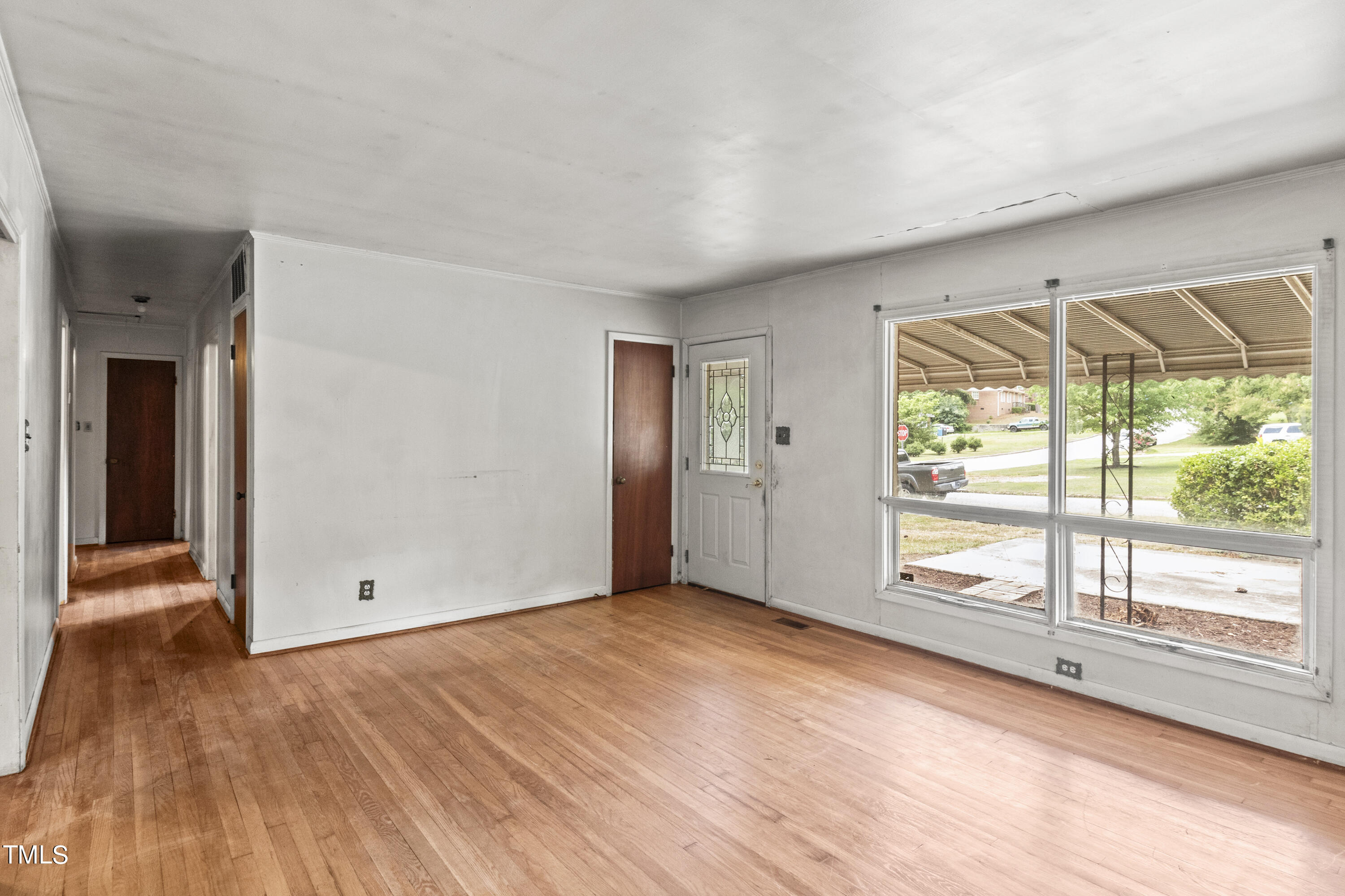 633 Ashford Street Raleigh, NC 27610 - Photo 8 of 25 a view of empty room with wooden floor and fan