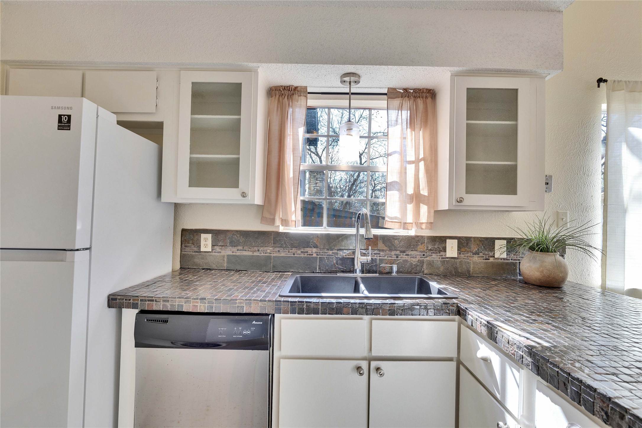 1002 Bodark Lane Austin, TX 78745 - Photo 12 of 35 a kitchen with stainless steel appliances granite countertop a sink stove and refrigerator