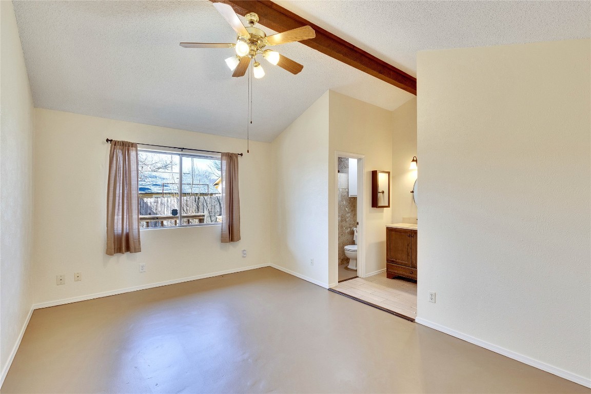 1002 Bodark Lane Austin, TX 78745 - Photo 15 of 35 an empty room with chandelier fan and windows