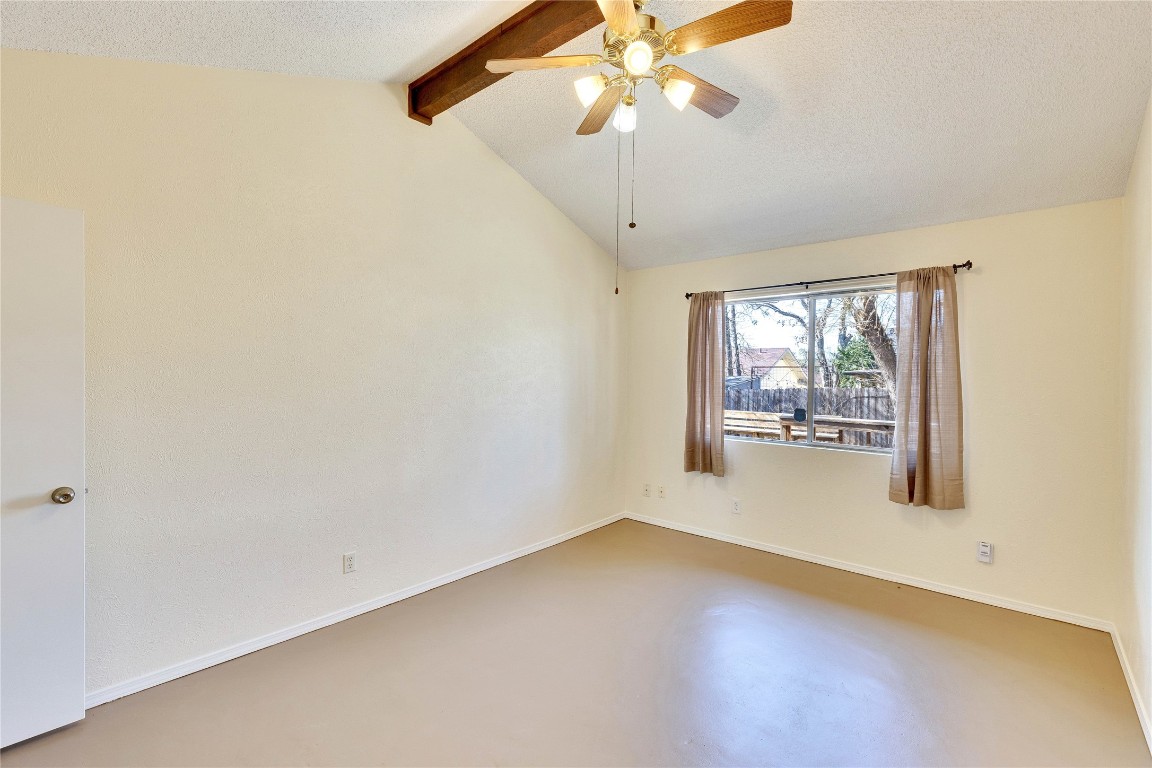 1002 Bodark Lane Austin, TX 78745 - Photo 16 of 35 an empty room with a chandelier fan and windows
