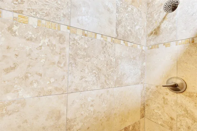 a white toilet sitting next to a shower