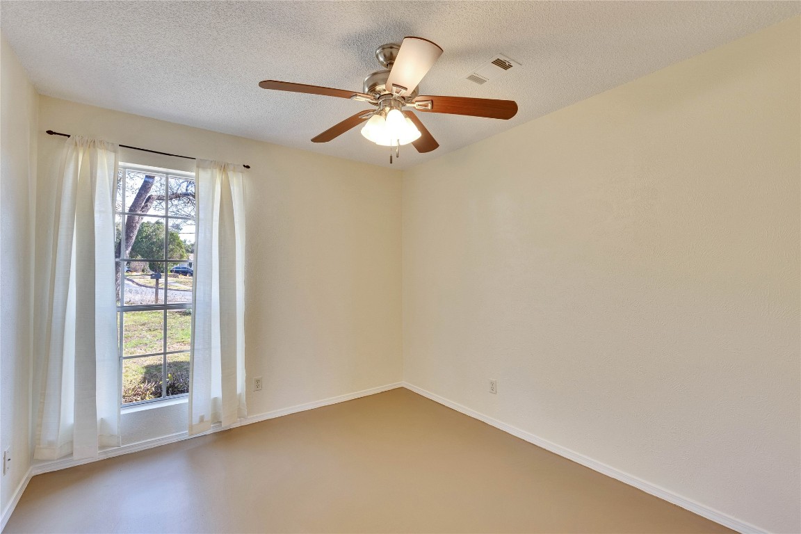 1002 Bodark Lane Austin, TX 78745 - Photo 23 of 35 an empty room with windows and fan