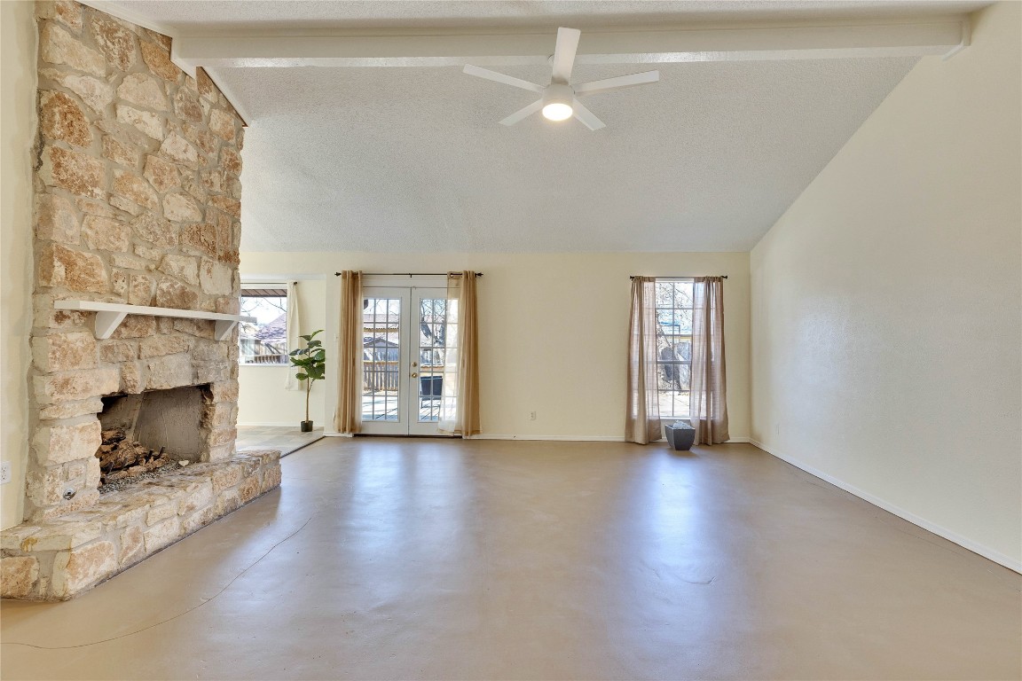 1002 Bodark Lane Austin, TX 78745 - Photo 6 of 35 a view of a livingroom with wooden floor a fireplace and windows