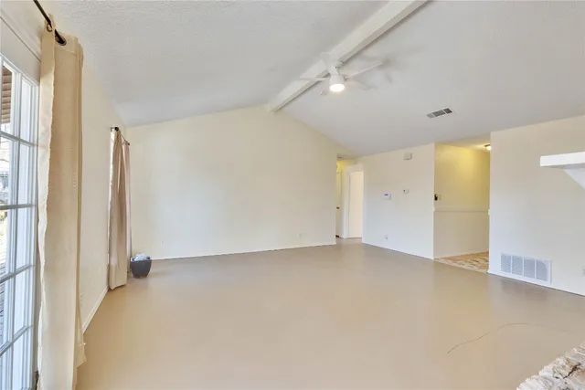 a view of a livingroom with wooden floor a fireplace and windows