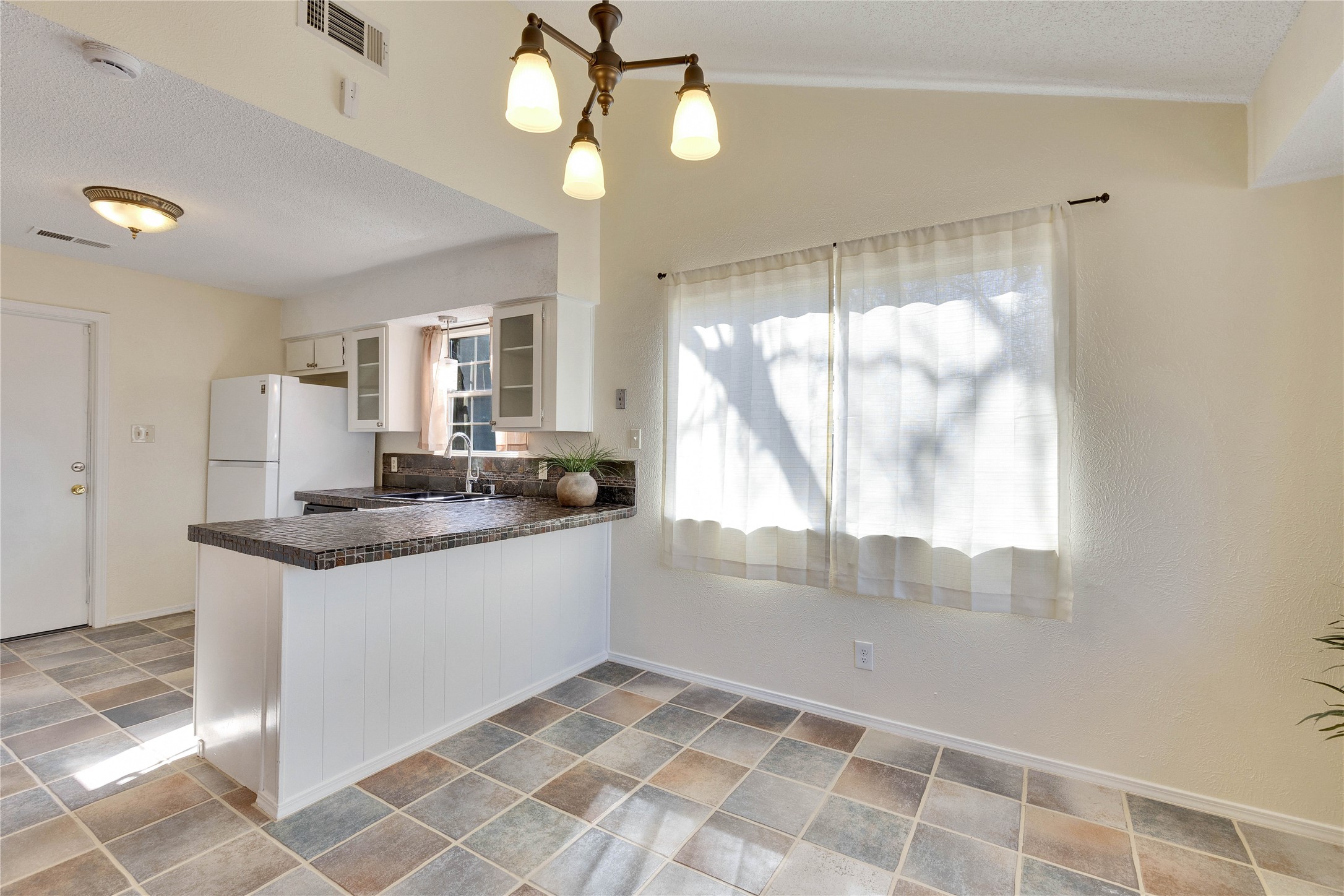 1002 Bodark Lane Austin, TX 78745 - Photo 8 of 35 a kitchen with granite countertop a sink and a stove top oven