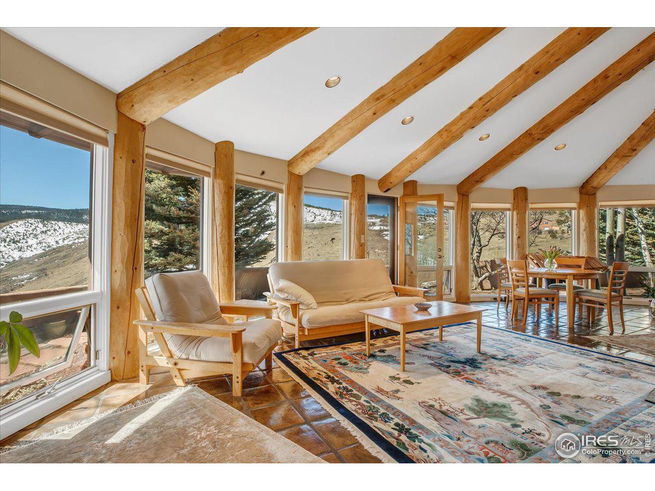515 Lost Angel Road Boulder, CO 80302 - Photo 3 of 37 a living room with furniture a fireplace and large windows