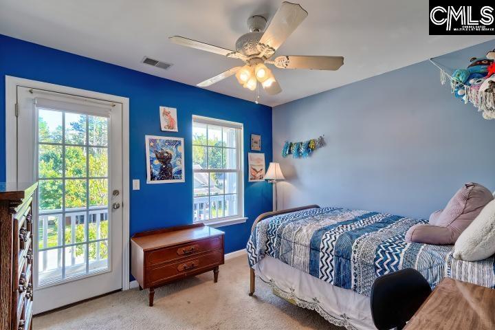 209 Eagle Pointe Drive Chapin, SC 29036 - Photo 28 of 40 a bedroom with a bed and a chandelier