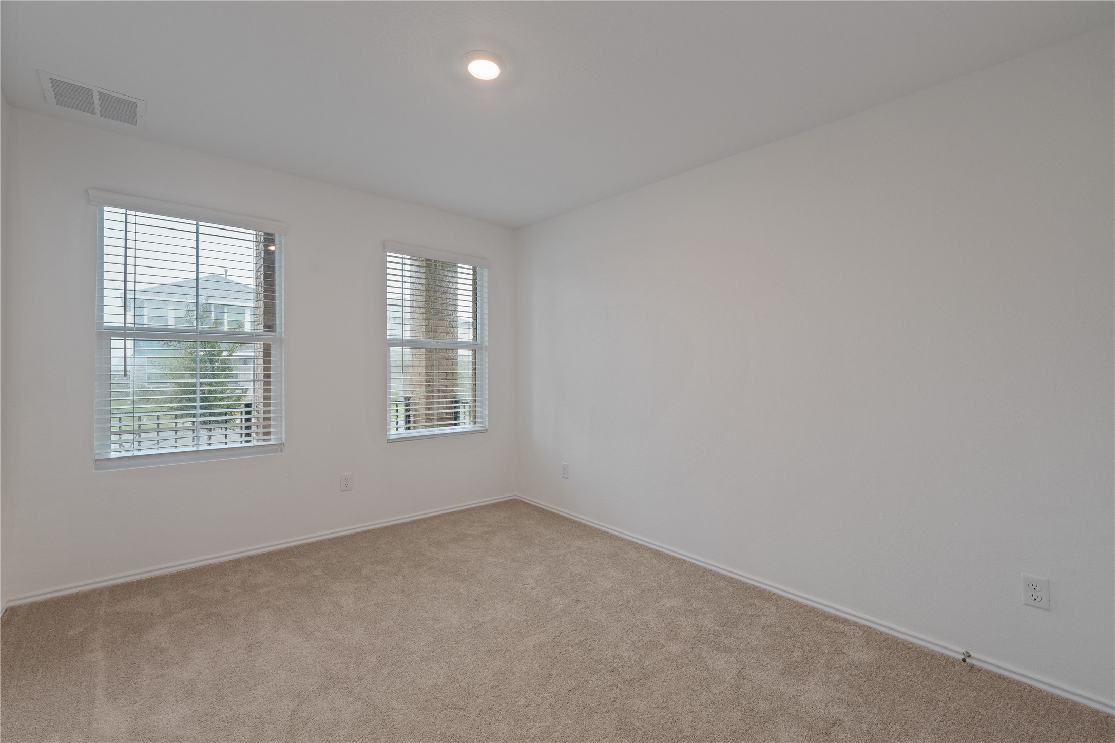 115 Parsons Kyle, TX 78640 - Photo 13 of 18 A well-lit room offers comfort with soft carpeting and modern recessed lighting.