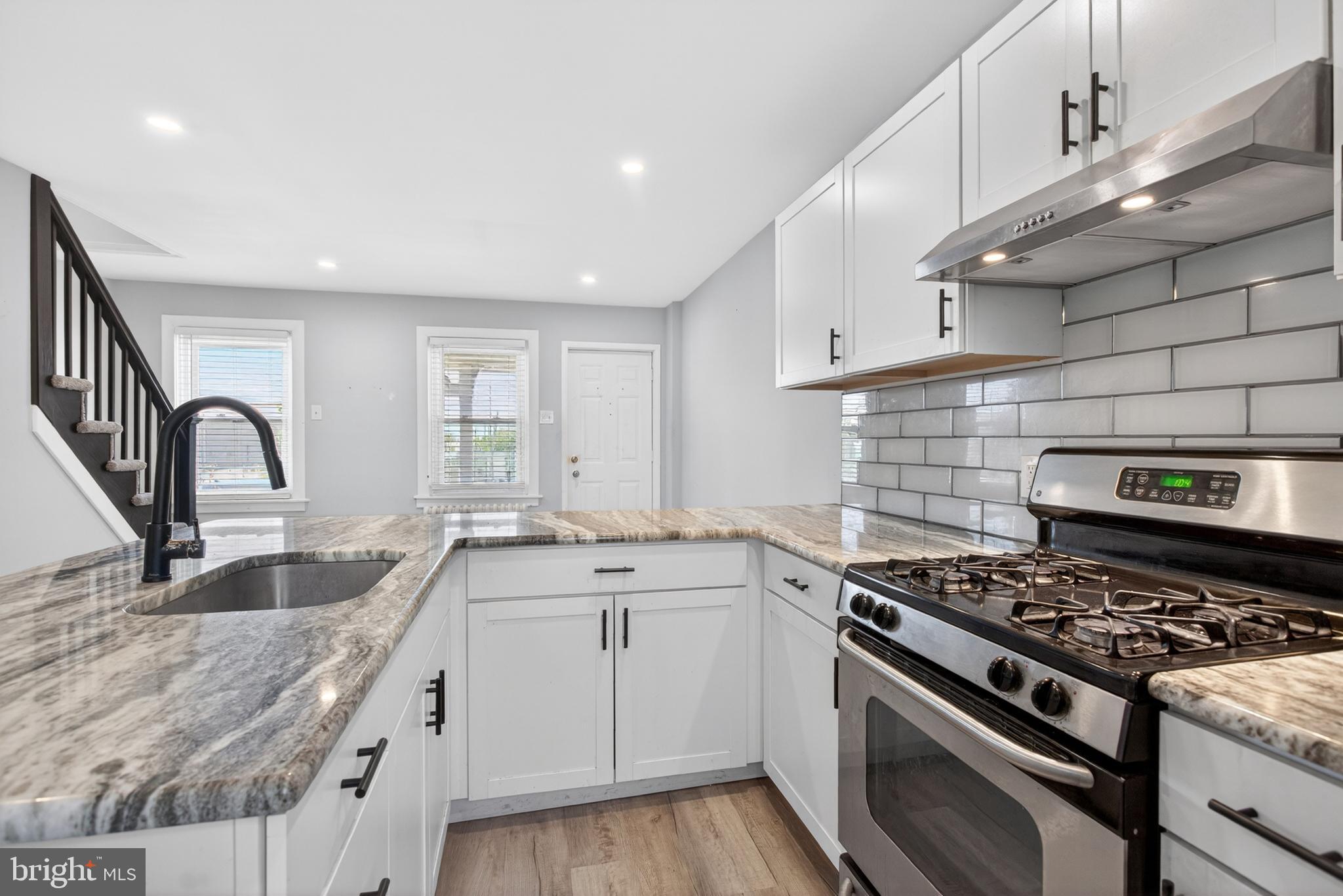 1122 West Ridge Road Marcus Hook, PA 19061 - Photo 11 of 27 a kitchen with granite countertop a sink stove and cabinets