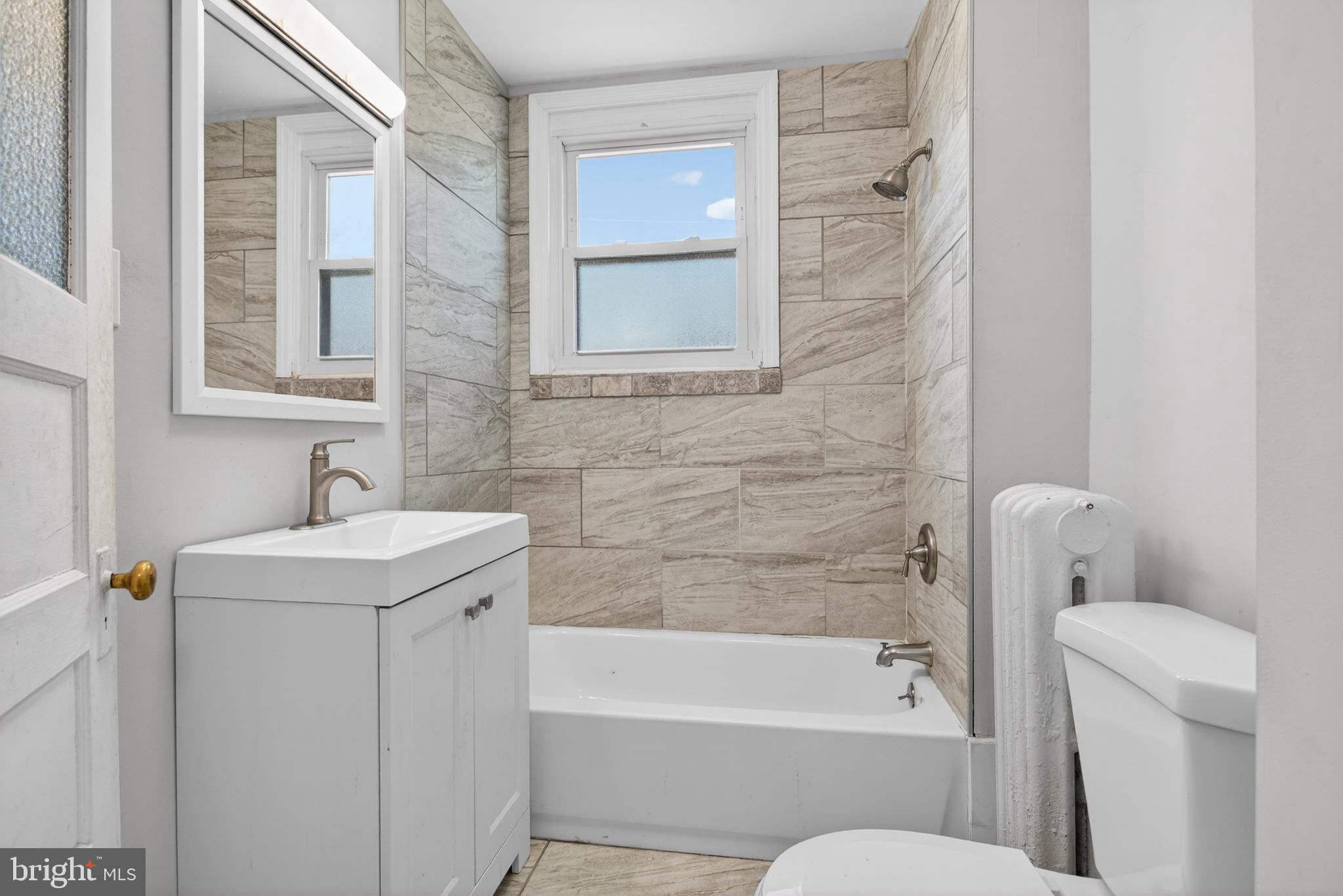 1122 West Ridge Road Marcus Hook, PA 19061 - Photo 16 of 27 a bathroom with a sink a toilet and bathtub