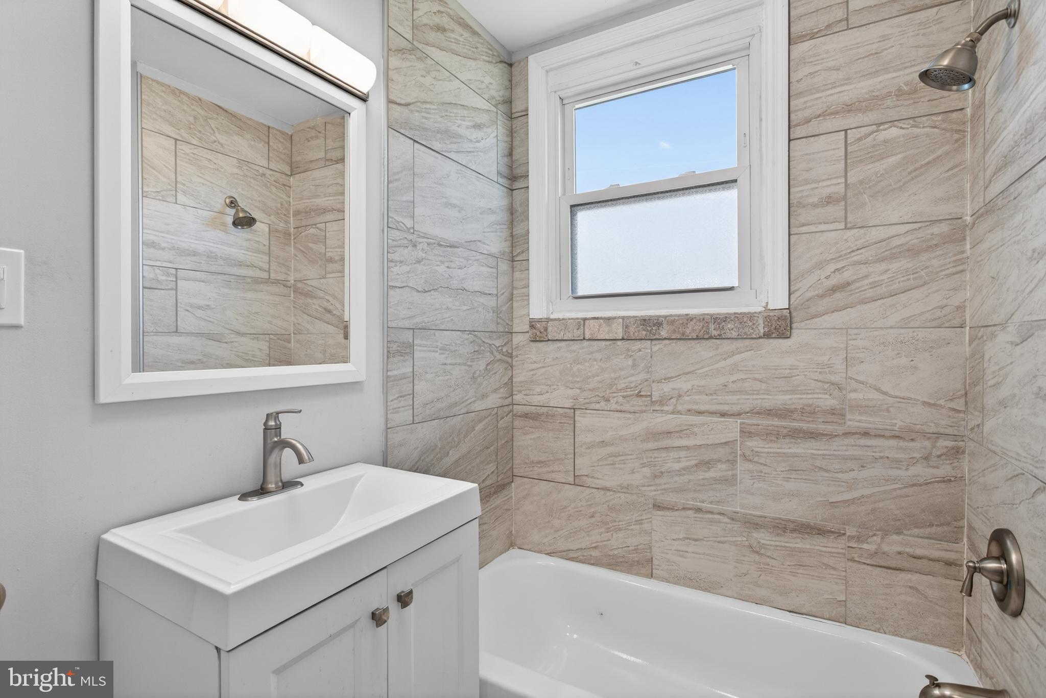 1122 West Ridge Road Marcus Hook, PA 19061 - Photo 17 of 27 a bathroom with a sink a bathtub and a shower