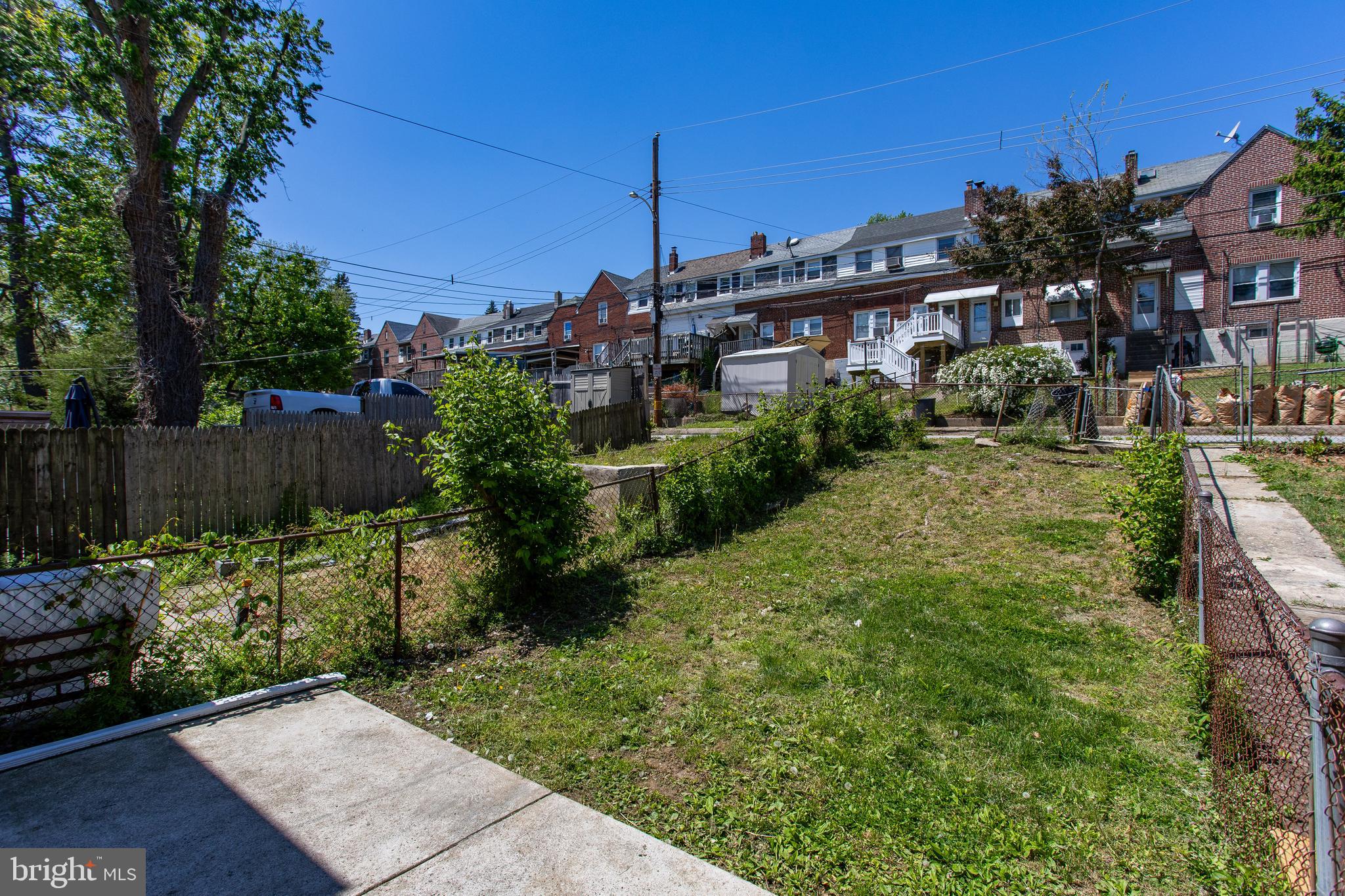 1122 West Ridge Road Marcus Hook, PA 19061 - Photo 23 of 27 a view of a house with a small yard and wooden fence