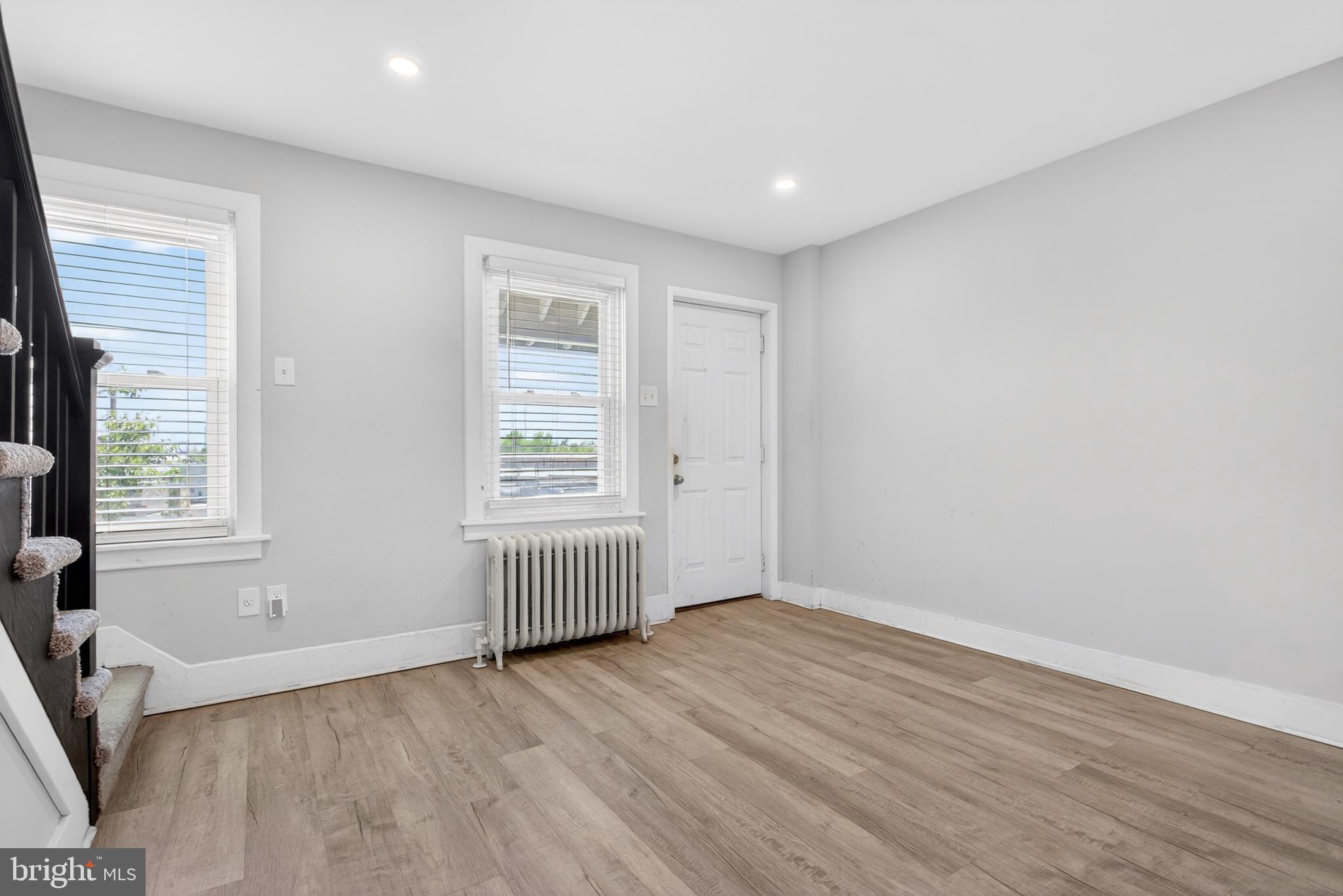 1122 West Ridge Road Marcus Hook, PA 19061 - Photo 7 of 27 an empty room with wooden floor and windows