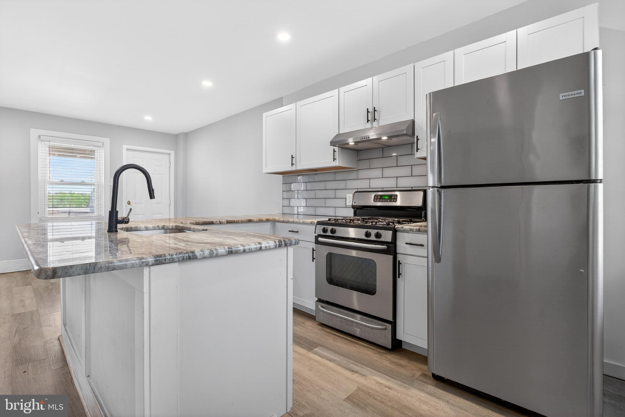 1122 West Ridge Road Marcus Hook, PA 19061 - Photo 9 of 27 a kitchen with stainless steel appliances a refrigerator and a stove top oven