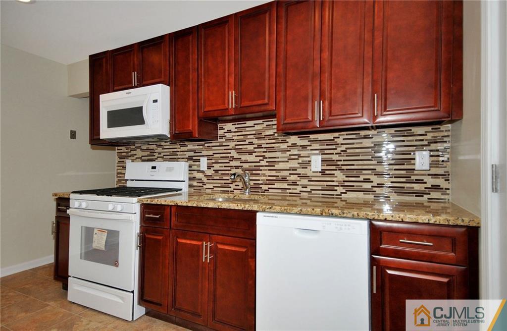 26 Cambridge Road Edison, NJ 08817 - Photo 1 of 17 a kitchen with stainless steel appliances granite countertop a stove microwave and cabinets