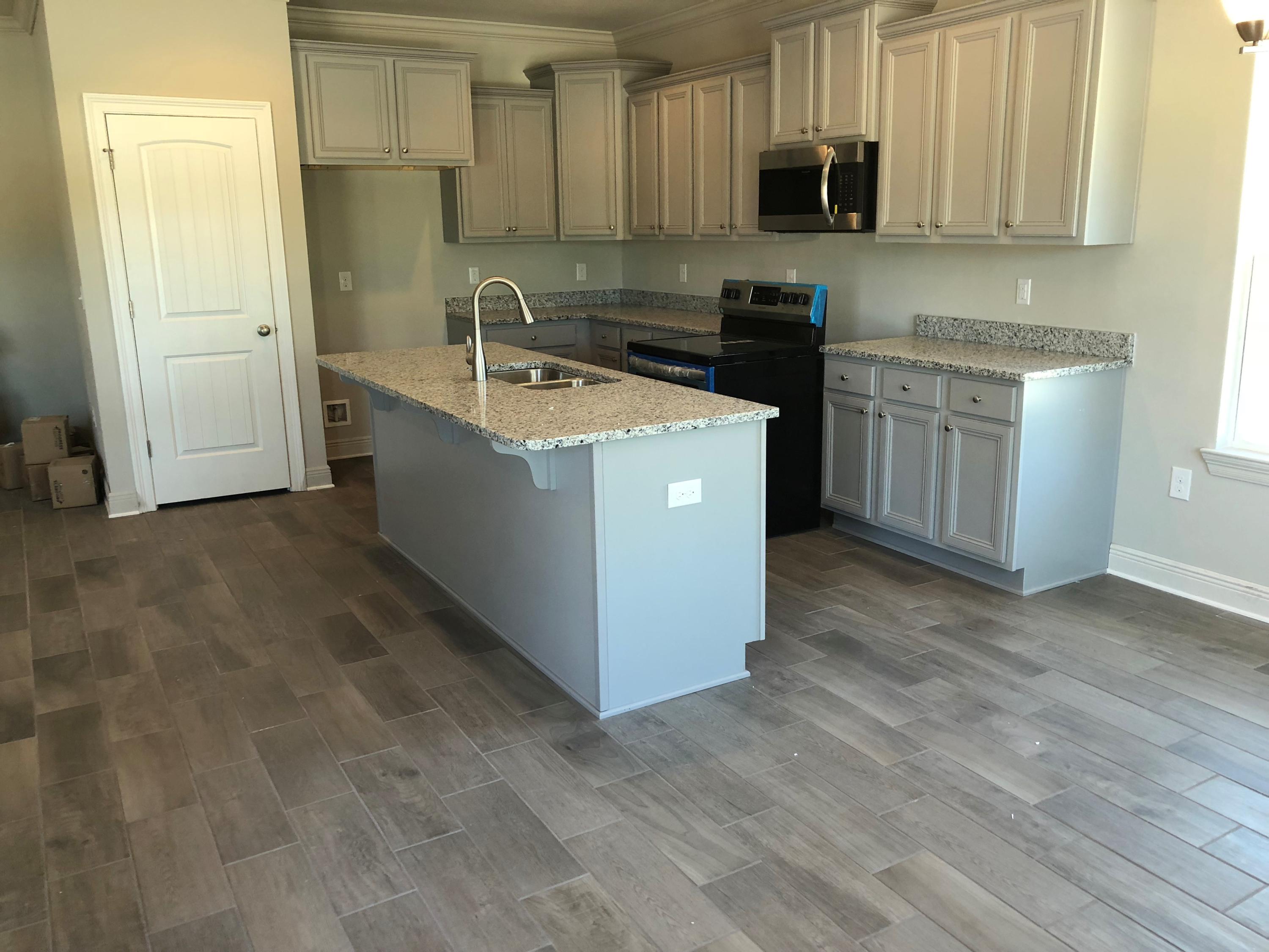 87 Wayne Trail Santa Rosa Beach, FL 32459 - Photo 2 of 11 a kitchen with stainless steel appliances granite countertop a sink and a stove top oven