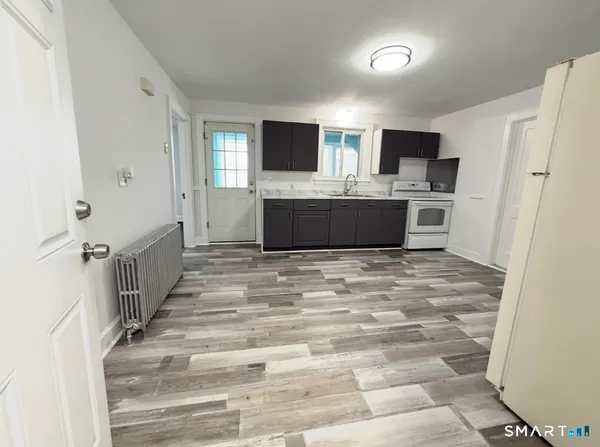 a view of a kitchen with microwave and refrigerator