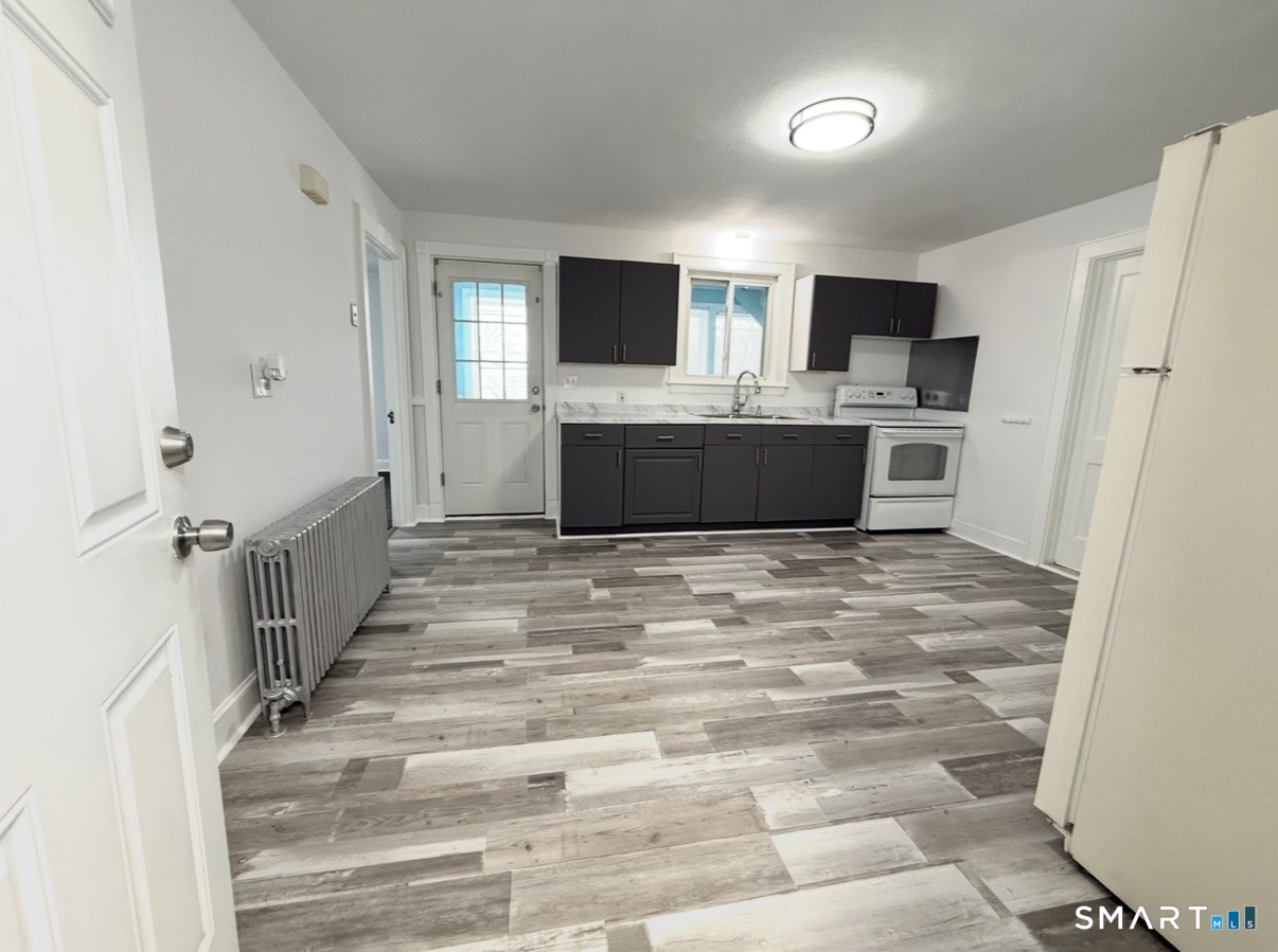 8 Garden Street Naugatuck, CT 06770 - Photo 4 of 14 a view of a kitchen with microwave and refrigerator