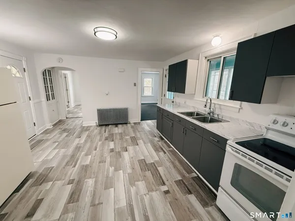 a kitchen with a sink and a stove top oven