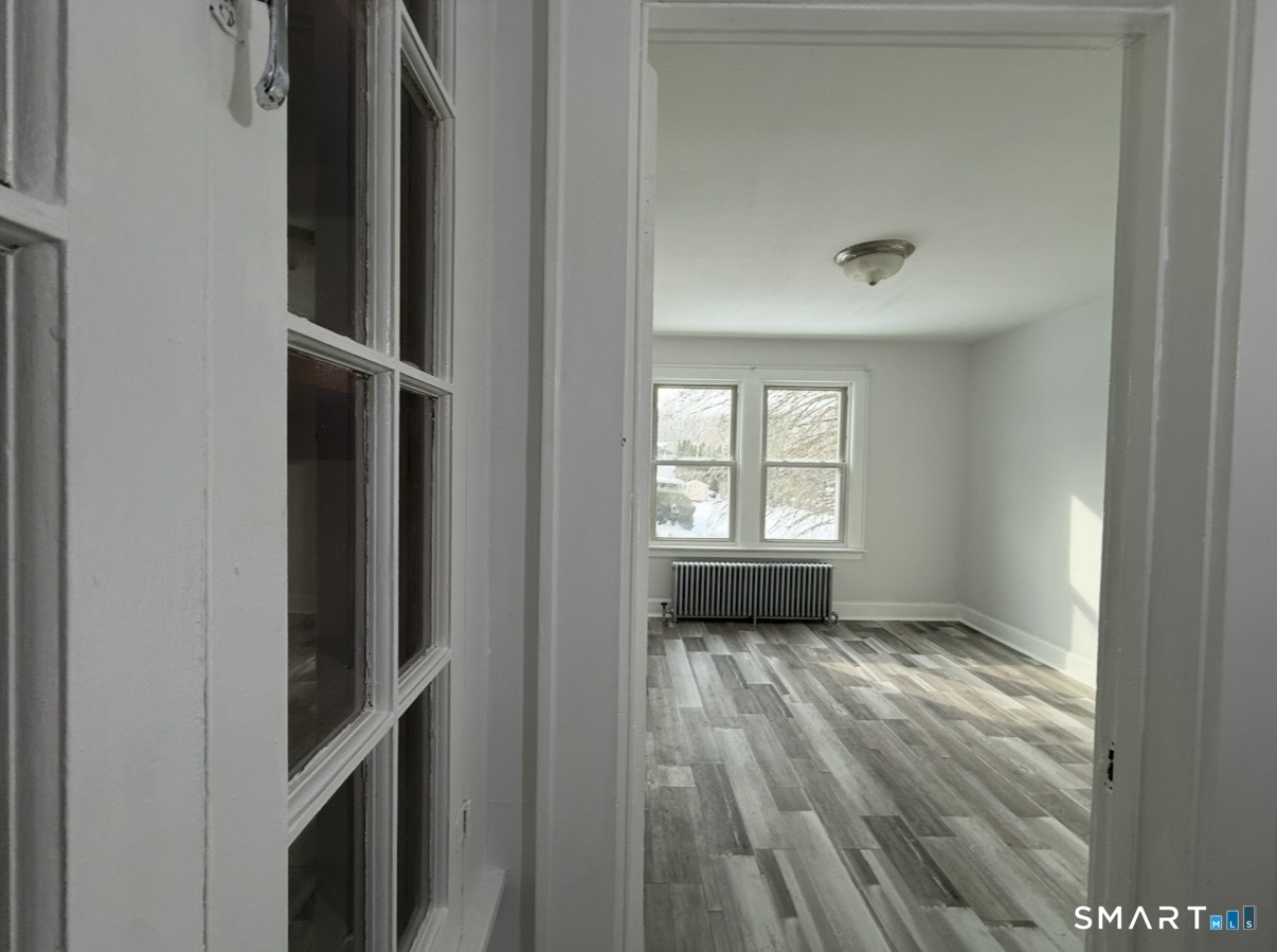 8 Garden Street Naugatuck, CT 06770 - Photo 7 of 14 a view of an empty room with a window and wooden floor