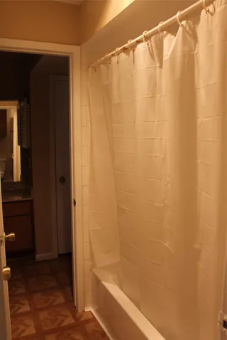 a bathroom with a shower and a bath tub