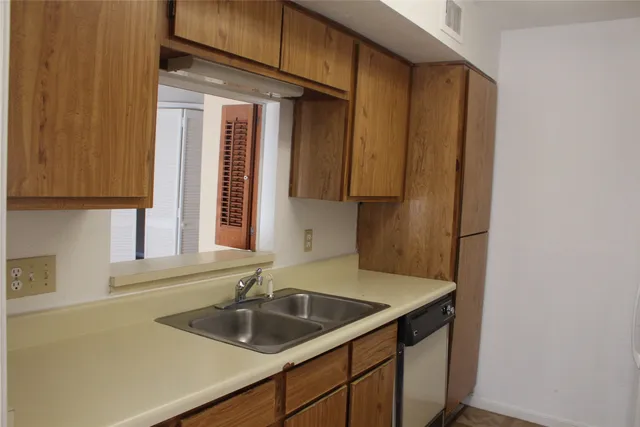 a kitchen with a sink and cabinets
