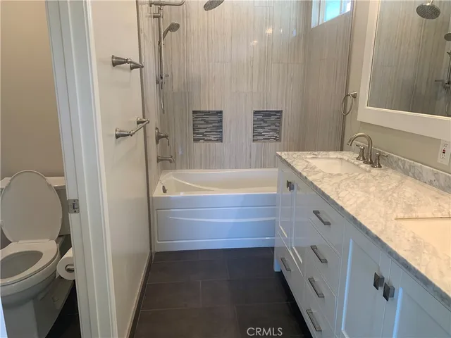 a white toilet sitting next to a white wall