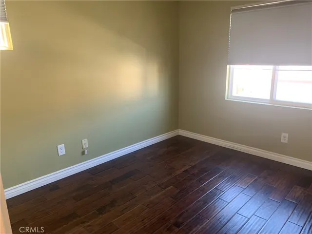 a view of a small space with wooden floor and windows
