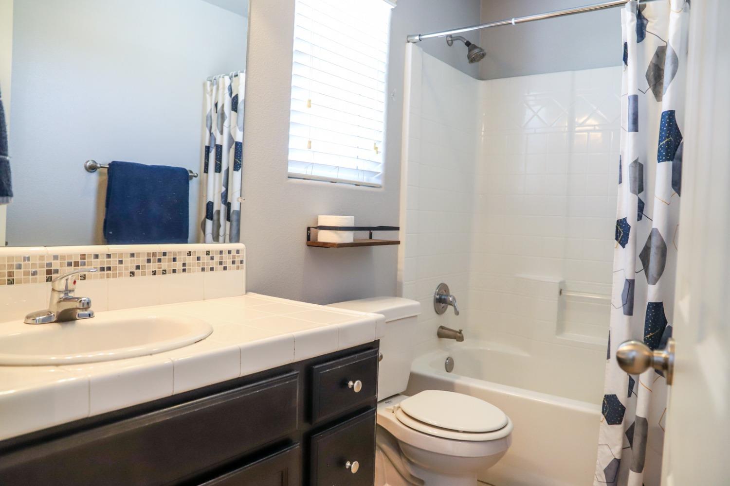3511 Generosity Way Clovis, CA 93619 - Photo 13 of 26 a bathroom with a sink a toilet and a mirror