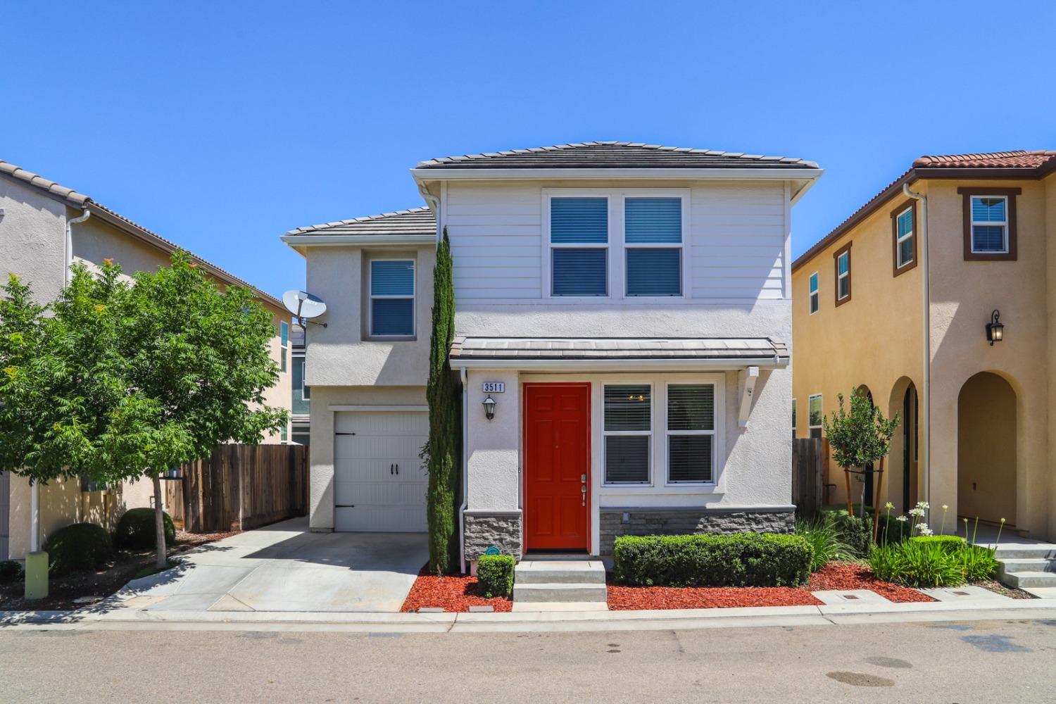 3511 Generosity Way Clovis, CA 93619 - Photo 2 of 26 a front view of a house with a yard and garage