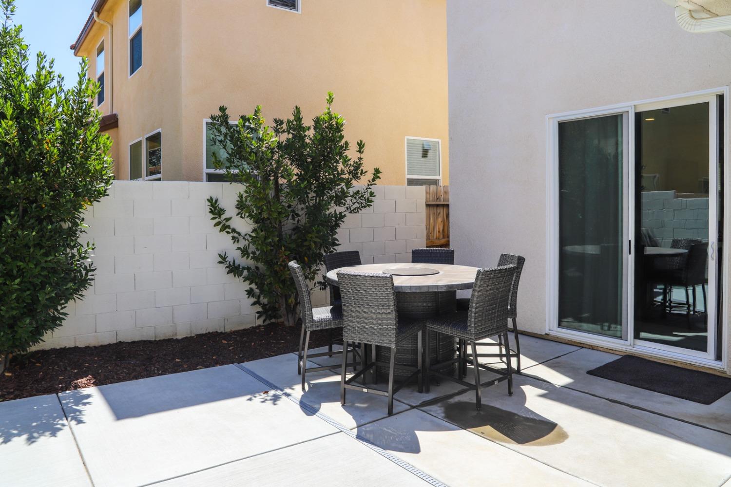 3511 Generosity Way Clovis, CA 93619 - Photo 5 of 26 a view of a patio with table and chairs and potted plants