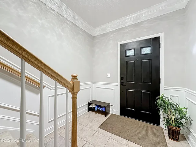 wooden floor fireplace and windows in an empty room