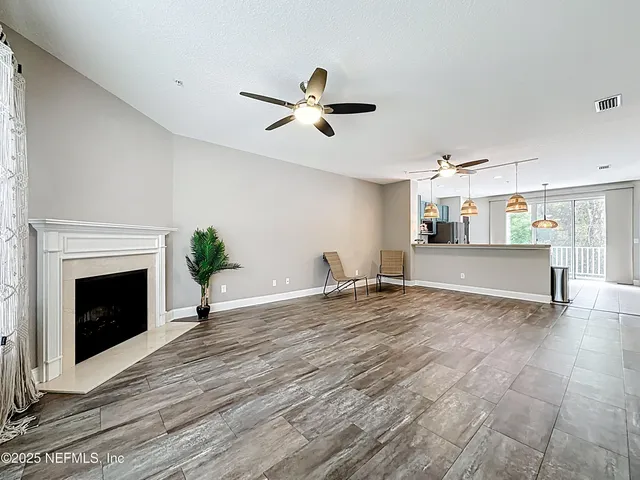 a view of a bedroom with a bed and wooden floor