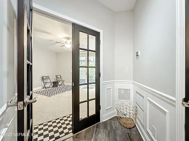 a living room with a bed furniture and a ceiling fan