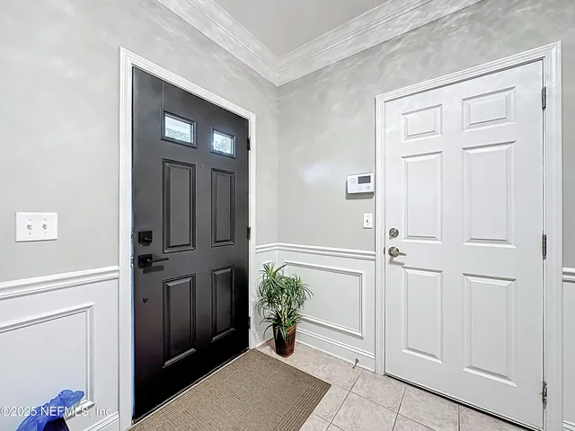 a view of a livingroom with a fireplace a ceiling fan and wooden floor