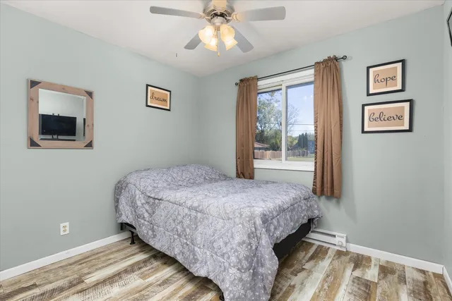 a bedroom with a bed and a window