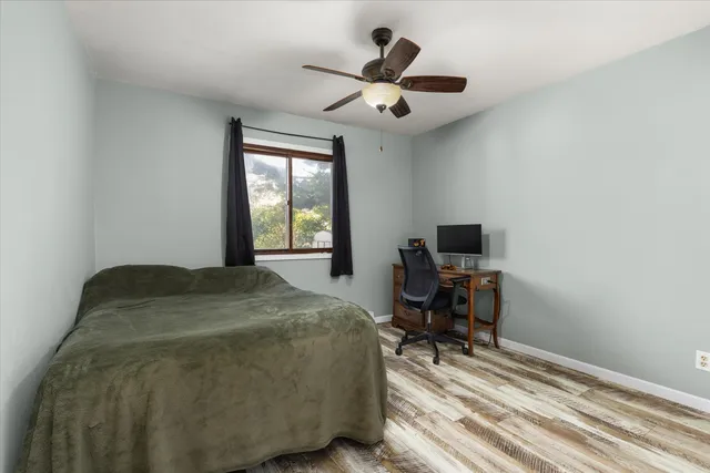 a bedroom with a large bed and a window