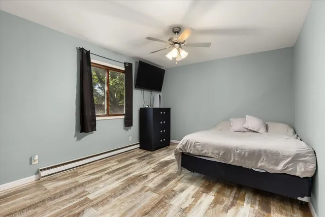 a bedroom with a large bed and a chandelier