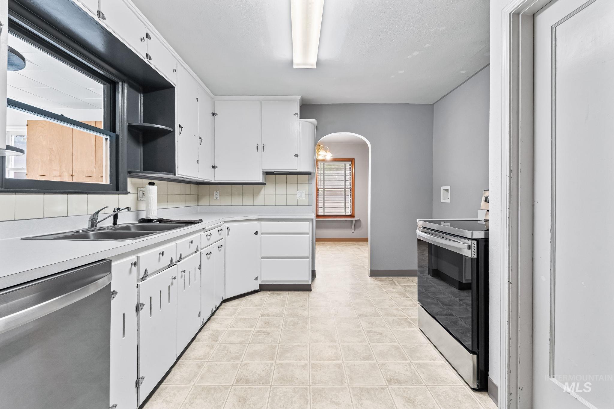 404 North Allumbaugh Street Boise, ID 83704 - Photo 22 of 31 Kitchen featuring stainless steel appliances, arched walkways, light countertops, and plenty of natural light