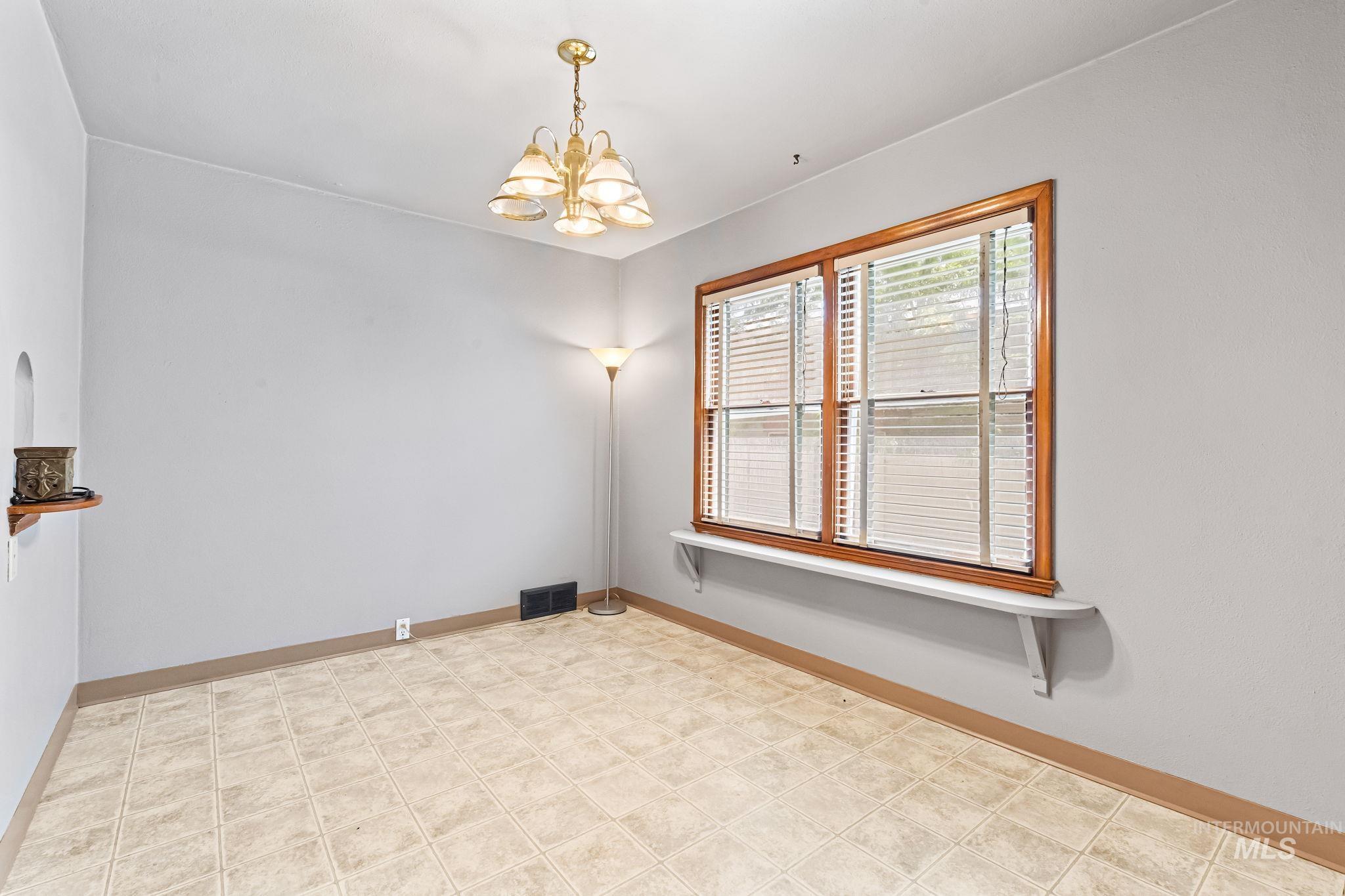 404 North Allumbaugh Street Boise, ID 83704 - Photo 25 of 31 Unfurnished dining area with a chandelier and light floors