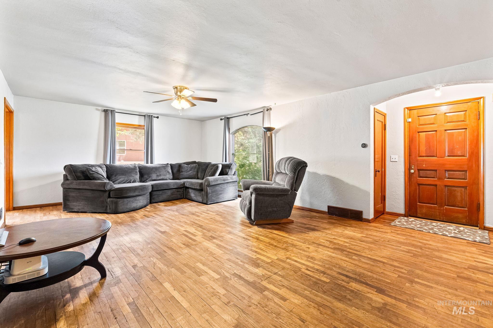 404 North Allumbaugh Street Boise, ID 83704 - Photo 27 of 31 Living area featuring hardwood / wood-style flooring, a ceiling fan, arched walkways, and plenty of natural light