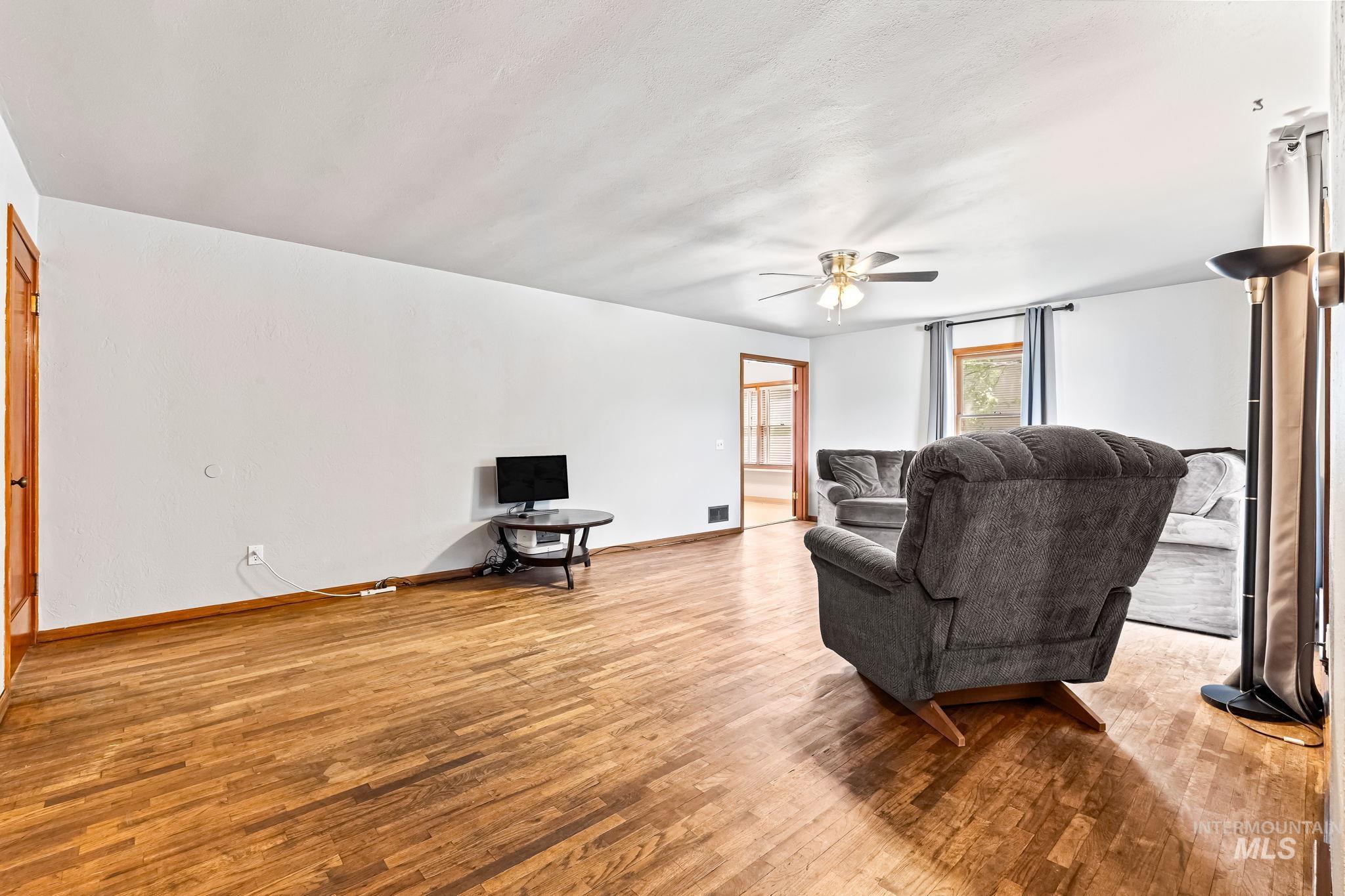 404 North Allumbaugh Street Boise, ID 83704 - Photo 28 of 31 Living room featuring wood finished floors and ceiling fan