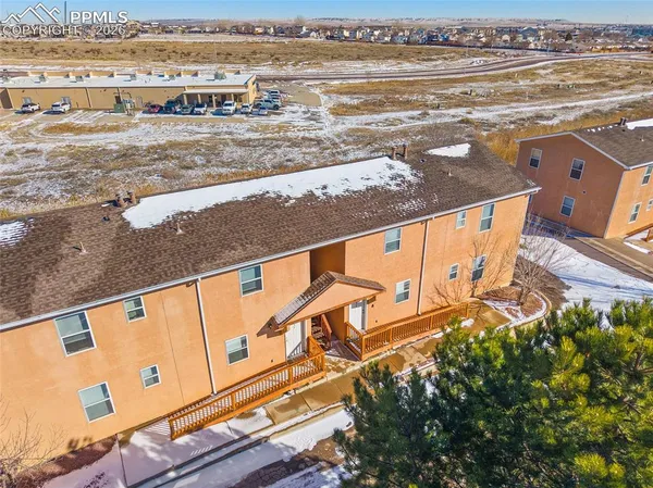 an aerial view of residential houses with outdoor space