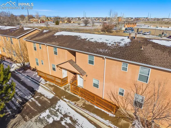 an aerial view of residential building and ocean