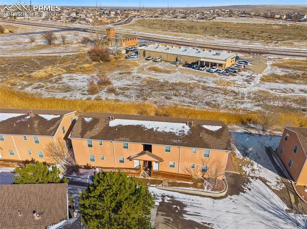 an aerial view of residential building and ocean view in back
