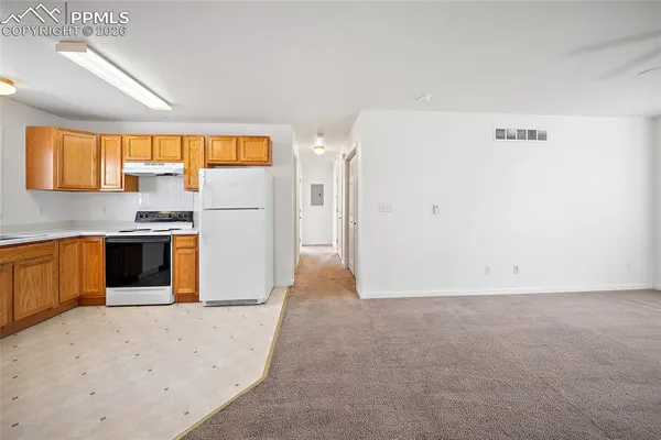 an empty room with a window and a ceiling fan