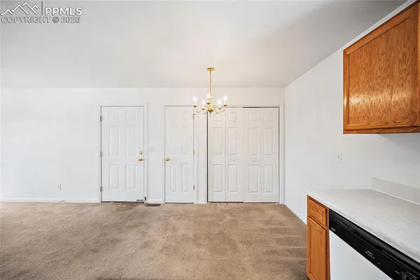 a view of a livingroom with a chandelier fan