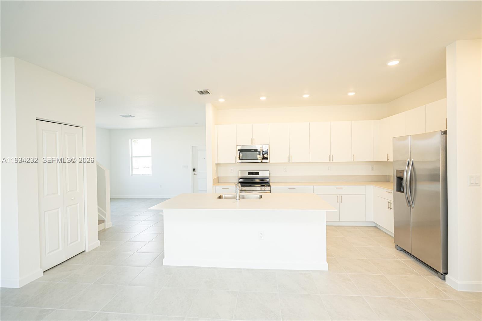 19507 Southwest 339th Terrace Homestead, FL 33034 - Photo 21 of 83 a large white kitchen with a refrigerator a sink and a large window