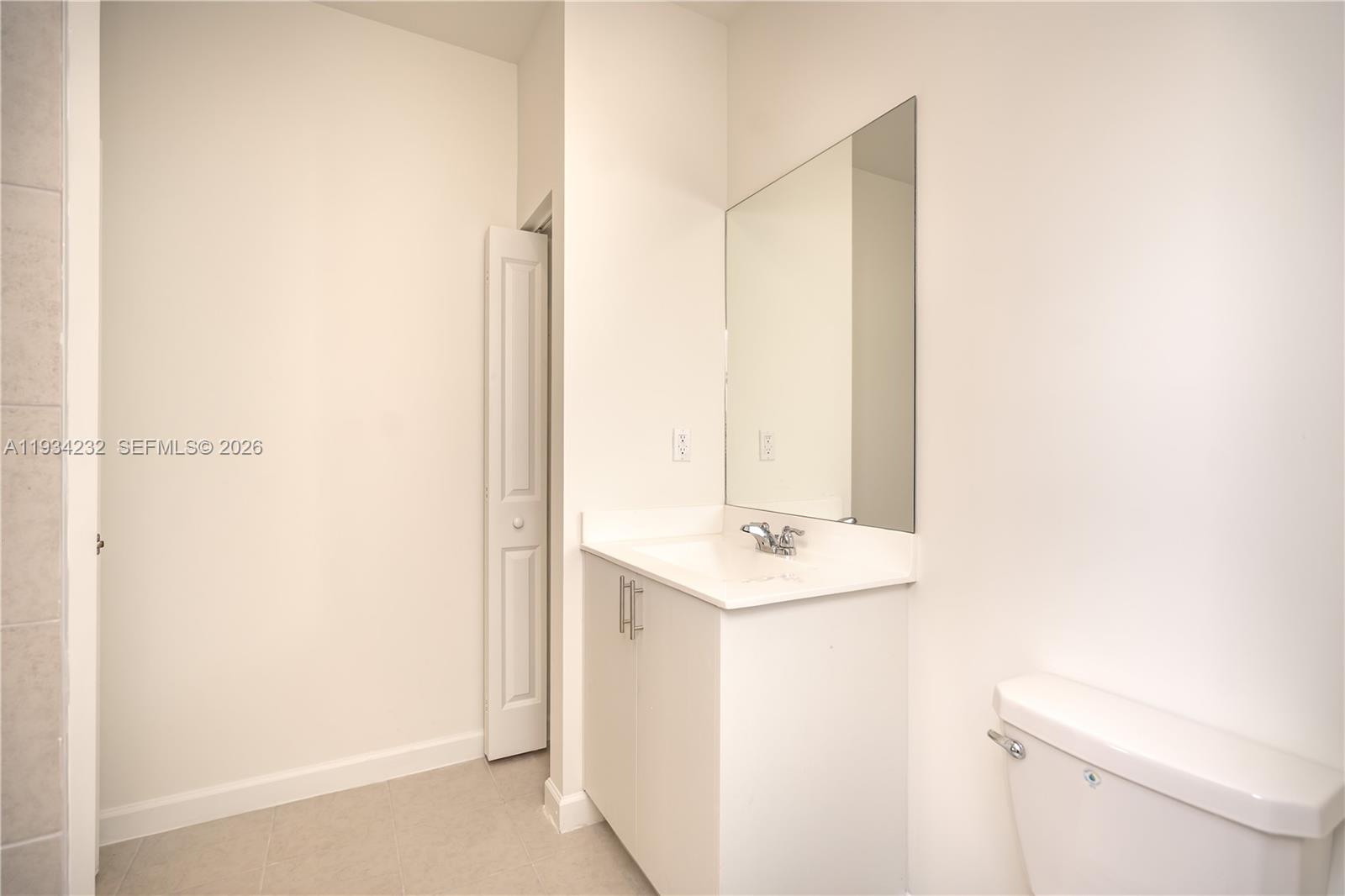 19507 Southwest 339th Terrace Homestead, FL 33034 - Photo 26 of 83 a bathroom with a sink a toilet and a mirror